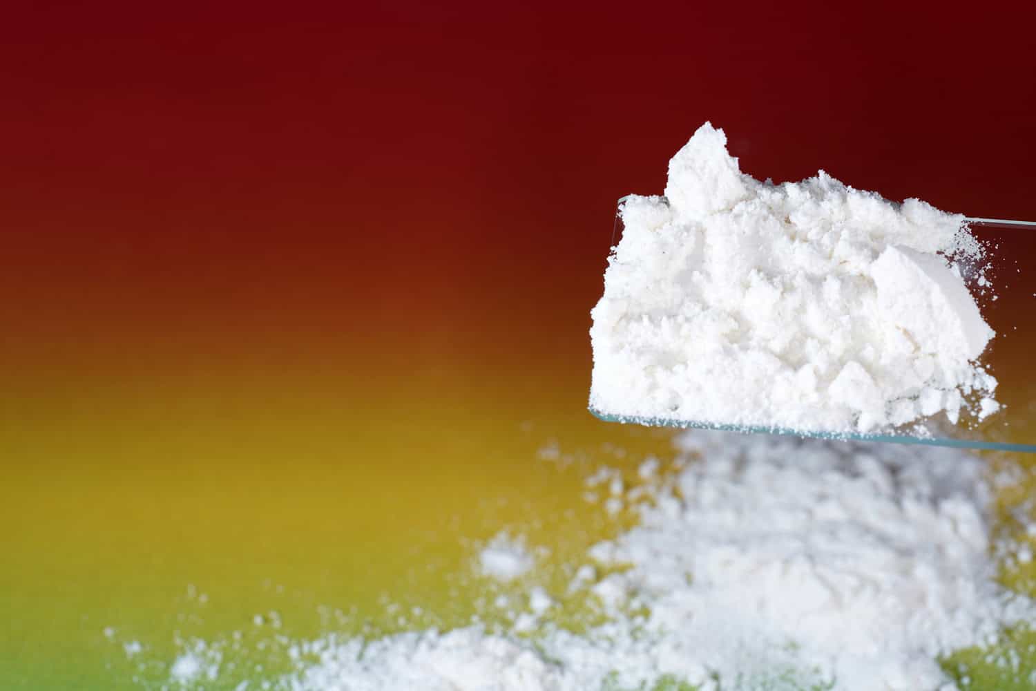 Closeup shot of white flour looking like drug on a colorful background