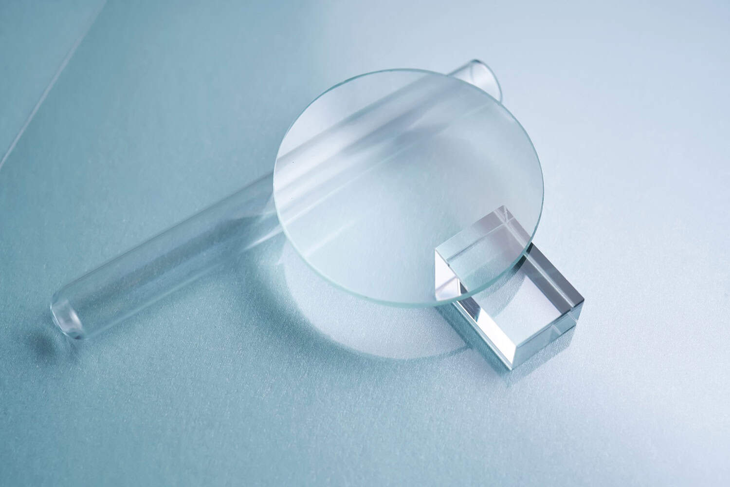 Glass objects and prisms on a blue background.