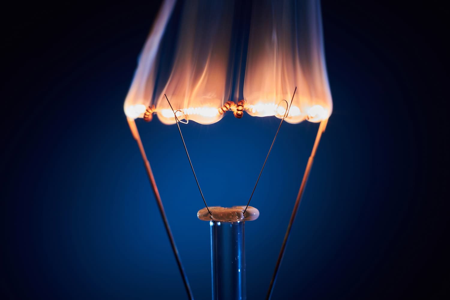 Electric bulb lamp with a burning spiral on a black background