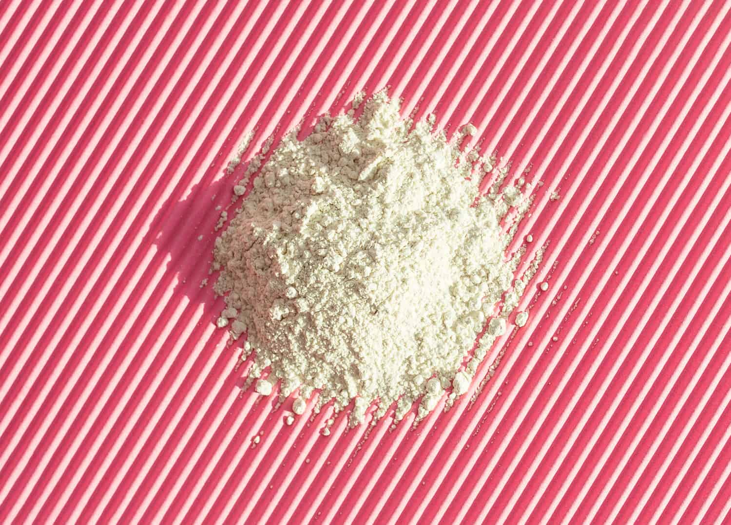 texture dry white clay on pink background
