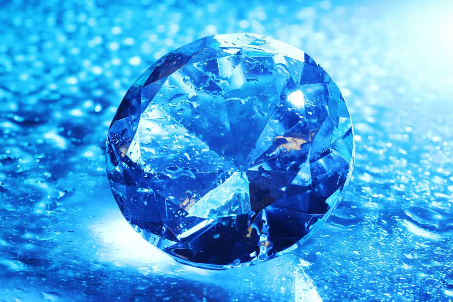 Big and beautiful jewel with water drops in blue light