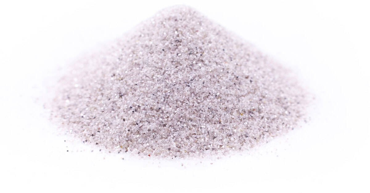 A close-up view shows a pile of white, sparkly diamond powder that sits on a stark, white background.